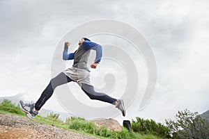 Low angle, runner and man running in nature training, cardio exercise and endurance workout for wellness. Sports
