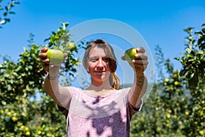 Happy woman in You pick apple orchard