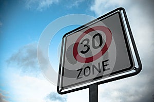 Low angle shot of a 30 speed limit sign