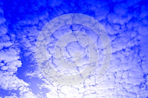 Low angle shot of aesthetically arranged clouds in the blue sky