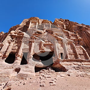 Low-angle shot of the ancient Al Khazneh in Petra Jordan under the blue sun sky