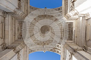 Low angle shot of arched ceiling building with engravements in Commerce Square of Lisbon, Portugal