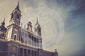 Low angle shot of the beautiful Catedral de la Almudena under the cloudy sky in Madrid, Spain photo