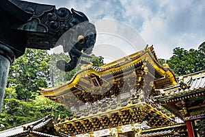 Low angle shot of the beautiful golden Yomeimon Gate at Toshogu Shrine in Nikko, Japan