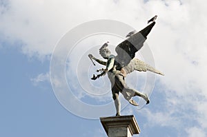 Low angle shot of beautiful statue of the Greek god Anteros under blue sky
