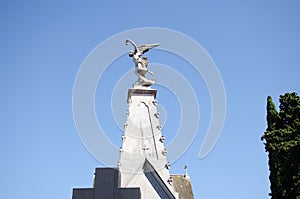 Low angle shot of beautiful statue of the Greek god Anteros under blue sky