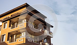 Low angle shot of a brown building with balconies