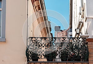 Low angle shot of a building with a balcony with flowerpots on it