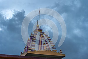 Low angle shot of a building colorful roof on a cloudy sky background