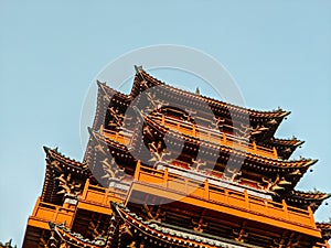 Low angle shot of the building under the sunlight and a blue sky in Millennium City Park, Kaifeng