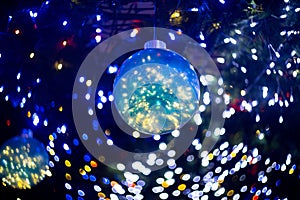 Low angle shot of a Christmas tree ornament with bokeh lights in the background