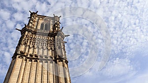 Low-angle shot of the Church of St. Martin in Clamecy against a blue cloudy sky photo