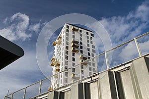 Low angle shot of a city apartment with a blue sky in the background
