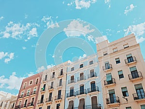 Low angle shot of a colorful apartment building against cloudy sky
