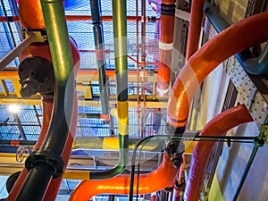 Low angle shot of colorful tobes in an industrial building