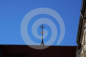 Low angle shot of a cross from the top of a church