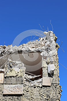 Low angle shot of a demolished old building under a blue sky