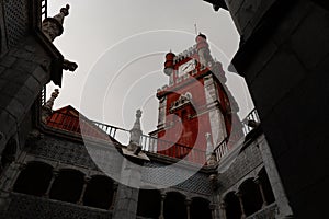 Low angle shot of the details in the main red clock tower of Pena Palace in Sintra, Portugal
