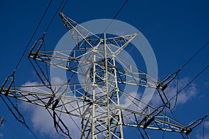 Low angle shot of an electricity tower with many cords attached