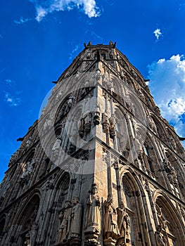 Low angle shot of the exterior of Cologne City Hall with stone figures on the walls