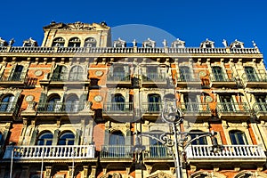 Low angle shot of the facade of an elegant building at Plaza del Castillo, Pamplona, Spain photo