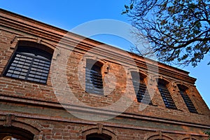 Low angle shot of the facade of a modern brick building under a blue clear sky