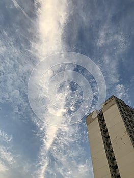 Low angle shot of the facade of the tall building under a scenic sky