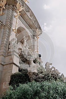 Low-angle shot of a fountain and a statue at Parc de la Ciutadella park in Barcelona photo