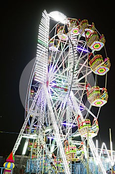 Low angle shot of Giant ferris wheel with Beautiful lighting in An Exhibition indian Fair at night in raipur, chhattisgarh, NIght