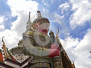 Low angle shot of a giant red demon statue at wat phra kaew in bangkok