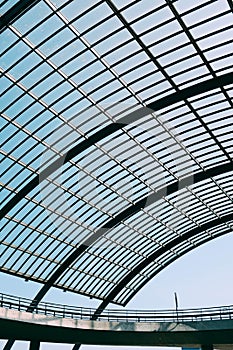 Low angle shot of a glass roof of a modern building under the blue sky