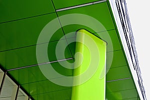 Low Angle Shot of a green sustaining pillar of the building facade photo
