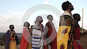 Low angle shot of a group of maasai women and men from a village near maasai mara dancing