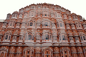 Low angle shot of Hawa Mahal from across the street. Hawa Mahal is constructed of red and pink sandstone. The structure was built