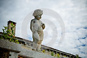 Low angle shot of a historic baby sculpture in Venice, Italy photo