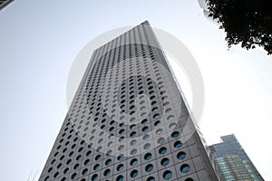 Low angle shot of Jardine house building against a cloudy sky in Hong Kong