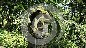 Low angle shot of a long-tailed macaque on a monkey statue in bali