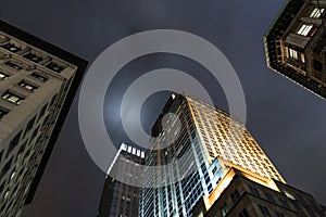 Low angle shot of Manhattan skyscrapers by night New York City, USA