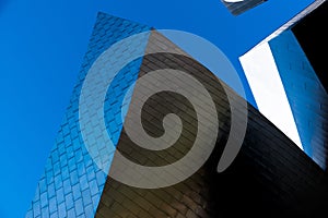 Low angle shot of modern architecture with pure blue sky in the background