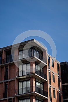 Low angle shot of a modern building facade on a blue sky background