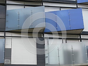 Low angle shot of a modern building facade with colorful glasses