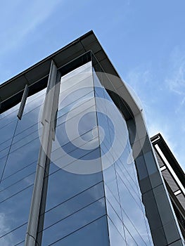 Low-angle shot of a modern business building under the blue sky