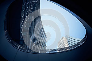 Low angle shot of modern curtain wall business buildings shot from underground passage during day