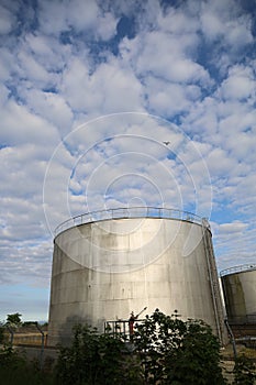 Low angle shot of an oil storage in Fredericia against the sky