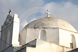 Low angle shot of an old chapel touching the cloudy sky in the Greek island of Folegandros