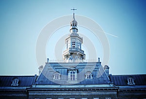Low angle shot of old Quebec Seminary tower of in Montreal, Quebec, Canada under blue sky