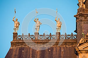 Low angle shot of old statues on top of a City hall building in Paris, France