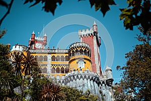 Low angle shot of Pena National Palace against blue sky on a sunny day in Sintra, Lisbon, Portugal
