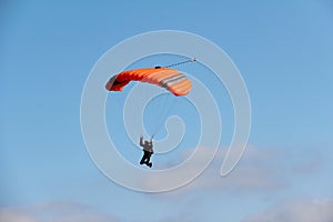 Low angle shot of a person parachuting in the sky