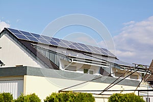 Low angle shot of pigeons on the PV solar panels on the roof of a modern house